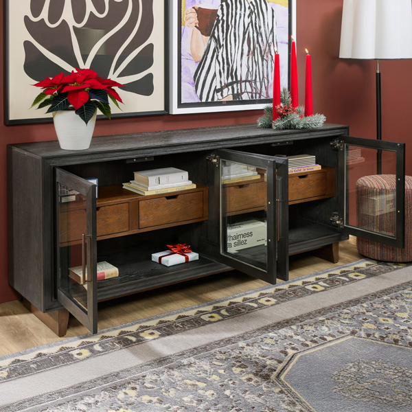 Black console table with open doors decorated for Christmas