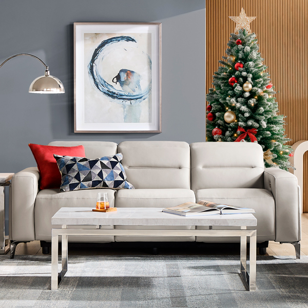 Modern sofa with a Christmas tree behind it