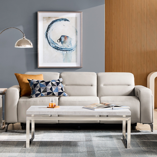 Contemporary white leather reclining sofa with toss pillows