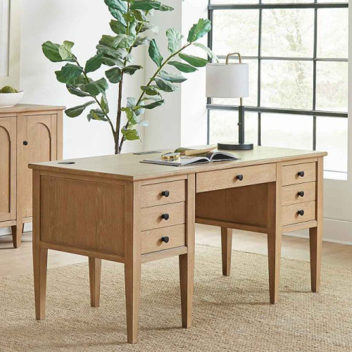 Wooden desk with a lamp on top